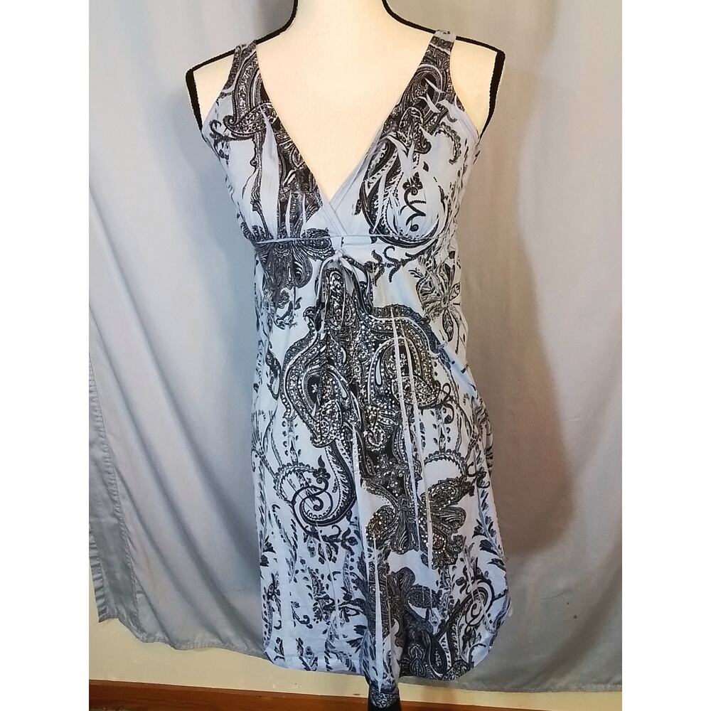 Press, Sleeveless blue dress with clear rhinestones.
